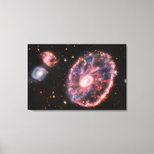 The Cartwheel Galaxy And Its Companion Galaxies. Canvas Print