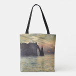 The Cliff Etretat, Sunset by Claude Monet Tote Bag<br><div class="desc">The Cliff, Etretat, Sunset (1883) by Claude Monet is a vintage impressionist fine art nautical painting. The sun is low in the sky over the ocean. A maritime seascape featuring a rocky outcrop near the shore at Etretat, France. About the artist: Claude Monet (1840-1926) was a founder of the French...</div>