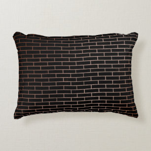 The dark black brick wall has a rough surface as a accent pillow