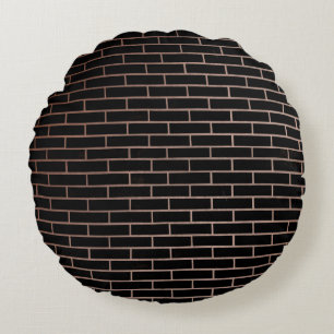 The dark black brick wall has a rough surface as a round pillow