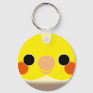 The face of a cinnamon pied male cockatiel keychain