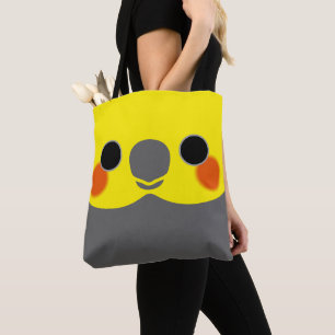 The face of a normal grey male cockatiel tote bag