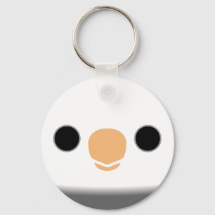 The face of a white-faced pied male cockatiel keychain