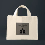 The Flame & Star - Mini Tote Bag<br><div class="desc">This image is a flame from a candle. A star around the flame represents Hanukkah. Done in a black tattoo. A black backround was also added. "Happy Hanukkah 2014" is printed on this design. Customize with your own words. These totes are available in assorted styles,  colours and sizes.</div>