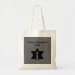 The Flame & Star - Tote Bag<br><div class="desc">This image is a flame from a candle. A star around the flame represents Hanukkah. Done in a black tattoo. A black backround was also added. "Happy Hanukkah 2014" is printed on this design. Customize with your own words. These totes are available in assorted styles,  colours and sizes.</div>