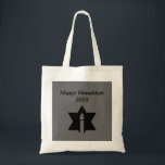 The Flame & Star - Tote Bag<br><div class="desc">This image is a flame from a candle. A star around the flame represents Hanukkah. Done in a black tattoo. A black backround was also added. "Happy Hanukkah 2014" is printed on this design. Customize with your own words. These totes are available in assorted styles, colours and sizes.</div>