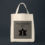 The Flame & Star - Tote Bag<br><div class="desc">This image is a flame from a candle. A star around the flame represents Hanukkah. Done in a black tattoo. A black backround was also added. "Happy Hanukkah 2014" is printed on this design. Customize with your own words. These totes are available in assorted styles,  colours and sizes.</div>
