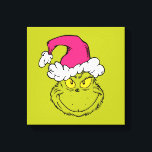 The Grinch in Pink Santa Hat Canvas Print<br><div class="desc">This fantastic, bold illustration is a close-up portrait of the Grinch in full mischievous mode! He has his signature sly grin and bright yellow eyes, but his look is updated with a large, fluffy Santa hat in a fun, unexpected pink/fuchsia color instead of the traditional red. This graphic is perfect...</div>