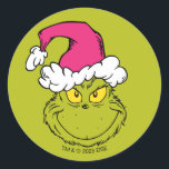 The Grinch in Pink Santa Hat Classic Round Sticker<br><div class="desc">This fantastic, bold illustration is a close-up portrait of the Grinch in full mischievous mode! He has his signature sly grin and bright yellow eyes, but his look is updated with a large, fluffy Santa hat in a fun, unexpected pink/fuchsia color instead of the traditional red. This graphic is perfect...</div>