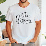 The Groom Calligraphy Wedding Name T-Shirt<br><div class="desc">This handsome "The Groom" tee features bold brush calligraphy with a customizable first name in clean uppercase lettering. The oversized black script on white creates a striking,  modern wedding look perfect for bachelor parties,  rehearsal dinners,  and getting-ready photos. Edit the name to personalize this monogram keepsake.</div>