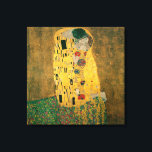 The Kiss by Gustav Klimt Canvas Print<br><div class="desc">The Kiss (Lovers) was painted by the Austrian Symbolist painter Gustav Klimt between 1908 and 1909, the highpoint of his "Golden Period", when he painted a number of works in a similar gilded style. A perfect square, the canvas depicts a couple embracing, their bodies entwined in elaborate robes decorated in...</div>