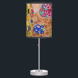 The Kiss by Gustav Klimt, Vintage Art Nouveau Table Lamp<br><div class="desc">The ultimate painting of love, a beautiful design to celebrate Valentine's Day with! The Kiss (detail) (1907-1908) by Gustav Klimt is a vintage Victorian Era Symbolism fine art love and romance painting featuring a romantic couple in various shades of gold, patterns and symbols, sharing a kiss against a bronze background....</div>