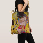 The Kiss by Gustav Klimt, Vintage Art Nouveau Tote Bag<br><div class="desc">Beautiful all-over-print tote bags! Available in two styles and two sizes! The ultimate painting of love, a beautiful design to celebrate Valentine's Day with!The Kiss (detail) (1907-1908) by Gustav Klimt is a vintage Victorian Era Symbolism fine art love and romance painting featuring a romantic couple in various shades of gold,...</div>