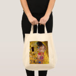 The Kiss by Gustav Klimt, Vintage Art Nouveau Tote Bag<br><div class="desc">The ultimate painting of love, a beautiful design to celebrate Valentine's Day with! The Kiss (detail) (1907-1908) by Gustav Klimt is a vintage Victorian Era Symbolism fine art love and romance painting featuring a romantic couple in various shades of gold, patterns and symbols, sharing a kiss against a bronze background....</div>