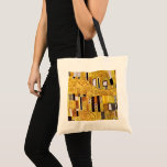 The Kiss Pattern by Gustav Klimt, Art Nouveau Tote Bag<br><div class="desc">The Kiss (pattern detail) by Gustav Klimt is a vintage fine art Victorian Era Symbolism painting. This detail is from a love and romance painting featuring a romantic couple in various shades of gold, symbols and patterns, sharing a kiss against a bronze background. About the artist: Gustav Klimt (1862-1918) was...</div>