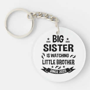 The little sister takes care of the big brother in keychain