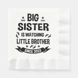 The little sister takes care of the big brother in napkin