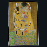 The Lovers Kissing Embrace by Gustav Klimt Medium Gift Bag<br><div class="desc">Sunlight glints off the swirling golden embrace that surrounds the lovers in Gustav Klimt's masterpiece, The Kiss. The scene is a paradox of intimacy and isolation. The couple stands on a precipice, a field of colourful flowers at their feet, yet they are oblivious to the world around them. Their gazes...</div>