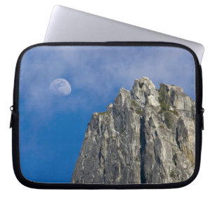 The moon rises and shines through the clouds laptop sleeve