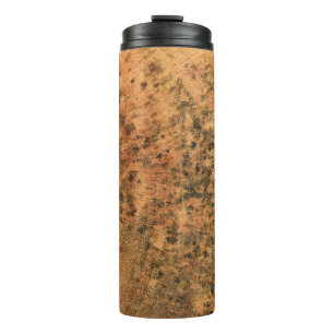 The mould that grows on the brown wood surface is  thermal tumbler