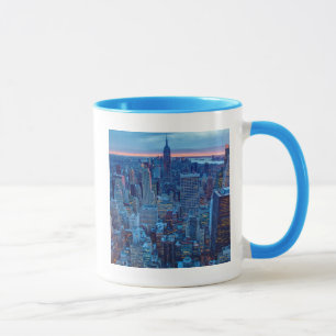 The skyscrapers of Manhattan are lit Mug