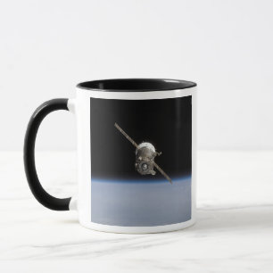 The Soyuz TMA-11 spacecraft above Earth's horiz Mug