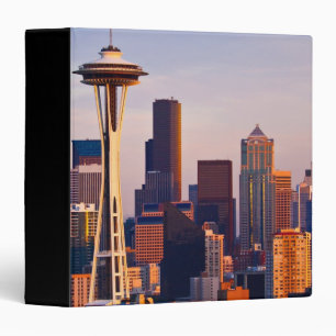 The Space Needle is a tower at dusk in Seattle Binder