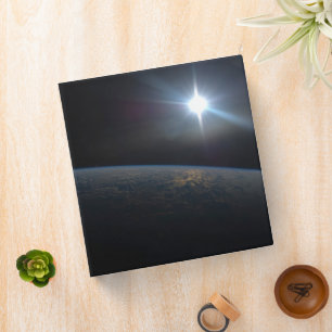 The Sun Setting Over Earth's Horizon. Binder