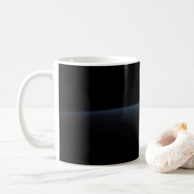 The Sun Setting Over Earth's Horizon. Coffee Mug (With Donut)