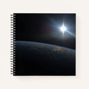 The Sun Setting Over Earth's Horizon. Notebook