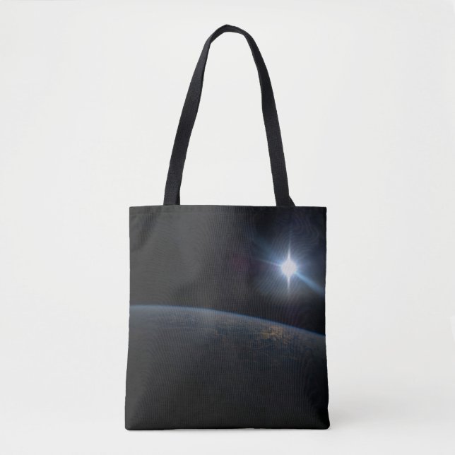 The Sun Setting Over Earth's Horizon. Tote Bag (Front)