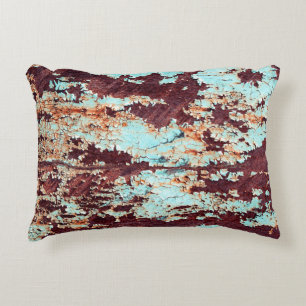 The texture of a rusty iron and a blue strongly pe accent pillow