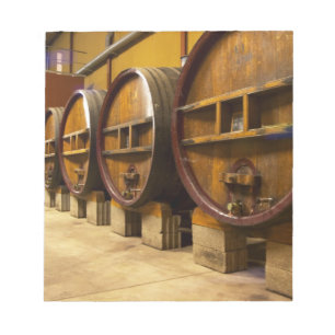 The wine cellar winery with big old wooden casks notepad