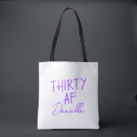 THIRTY AF Personalized Funny 30th Birthday Tote Bag<br><div class="desc">Celebrate turning 30 in bold style with this personalized “THIRTY AF” tote bag. Featuring vibrant purple text and your custom name in elegant script, this playful yet practical bag is perfect for birthday brunches, party essentials, or gift-giving flair. Whether you’re treating yourself or surprising your bestie, this tote adds sass...</div>