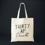 THIRTY AF Personalized Funny 30th Birthday Tote Bag<br><div class="desc">This personalized “THIRTY AF” tote bag is the ultimate 30th birthday accessory — bold, fun, and fabulously functional. Featuring a custom name in elegant script beneath the playful slogan, it’s perfect for brunches, gifting, errands, or that post-party coffee run. Made for birthdays with attitude, this bag is as stylish as...</div>