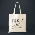 THIRTY AF Personalized Funny 30th Birthday Tote Bag<br><div class="desc">This personalized “THIRTY AF” tote bag is the ultimate 30th birthday accessory — bold, fun, and fabulously functional. Featuring a custom name in elegant script beneath the playful slogan, it’s perfect for brunches, gifting, errands, or that post-party coffee run. Made for birthdays with attitude, this bag is as stylish as...</div>