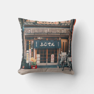 THREE BICYCLES PARKED IN FRONT OF BUILDING THROW PILLOW