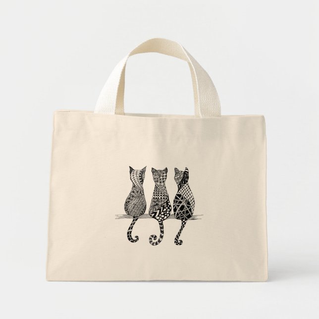 Three Black and white cats on a bag (Front)