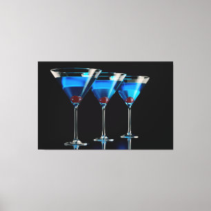 Three blue cocktails with cherry on black canvas print
