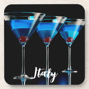 Three blue cocktails with cherry on black coaster