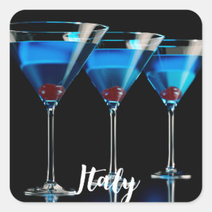 Three blue cocktails with cherry on black square sticker