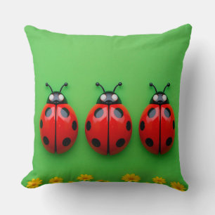 Three Colourful Ladybugs on Green Background Throw Pillow