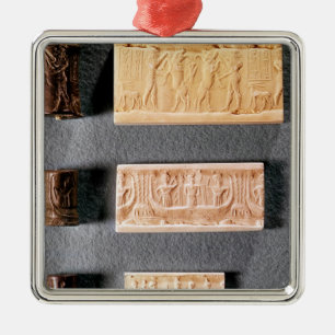 Three cylinder seals with impressions, metal ornament