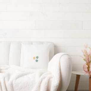 three flowers with green and orange petals throw pillow