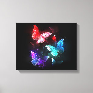 Three Glowing Butterflies on night background Canvas Print