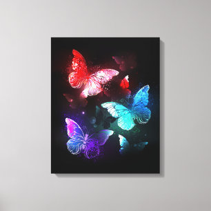 Three Glowing Butterflies on night background Canvas Print