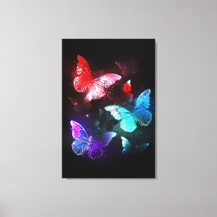 Three Glowing Butterflies on night background Canvas Print