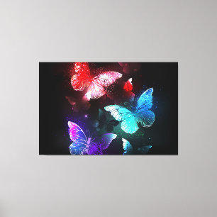 Three Glowing Butterflies on night background Canvas Print