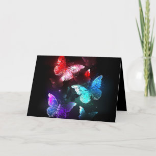 Three Glowing Butterflies on night background Card