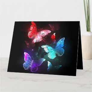 Three Glowing Butterflies on night background Card
